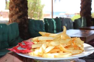 a plate of french fries on a table at Happy Camp in Nuweiba