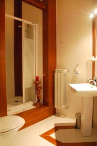 a bathroom with a toilet and a sink and a shower at Old Time Hotel in Krakow