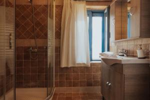 a bathroom with a shower and a sink at Sea Mansion Lefkada in Nikiana +36 photos