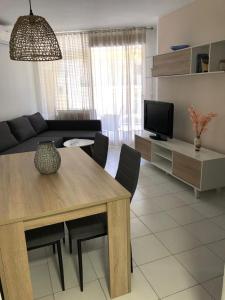 uma sala de estar com uma mesa de jantar e uma televisão em Calpe Apolo 7 Apt 51 em Calpe