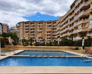 a swimming pool in front of a large apartment building at Calpe Apolo 7 Apt 51 in Calpe