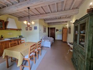 a kitchen and living room with a table and chairs at Agriturismo La Pieve in Pelago