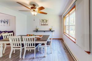 a dining room with a table and chairs and a ceiling fan at Penn Forest Paradise in Albrightsville
