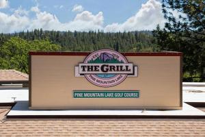 a building with a sign that reads the grill pine mountain lake golf course at New Luxury 5BR Cabin in Pine Mountain Lake! 1 Minute to Beach! Massage Chair! Close to Yosemite! Perfect for Retreats and Escapes All Seasons! in Groveland +78 photos