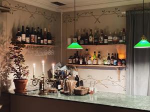 a bar with bottles of wine and candles at Hotell Åre Fjällsätra in Undersåker