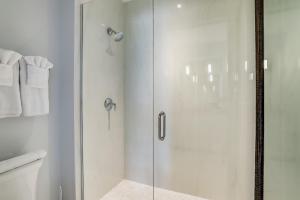 a shower with a glass door in a bathroom at The Heart of Naples in Naples +31 photos