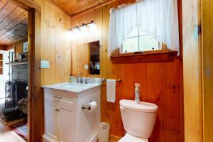 a bathroom with a toilet and a sink at Lake House Retreat in Ossipee +72 photos