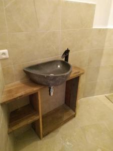 a bathroom with a sink on a wooden table at La tanière in Champs Sur Tarentaine