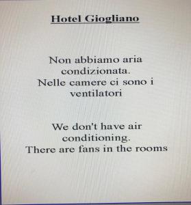 a white and blue sign on a white wall at Hotel Giogliano in Radicondoli