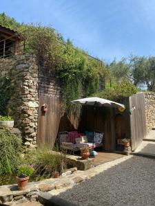 a patio with a table and an umbrella at La Bonne Rencontre in Chassiers