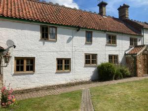 a white house with windows and a roof at Wensum House in Norwich