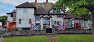 a house with british flags on the front of it at The Moores Castle Holiday Suites in Prestatyn