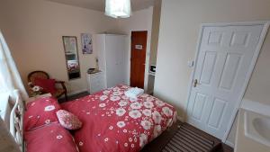 a bedroom with a bed and a white door at Tennyson Lodge in Mablethorpe