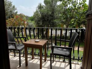 a porch with three chairs and a table on a balcony at Han Boutique Hotel in Sarigerme