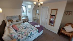 a bedroom with a bed and a sink in it at Tennyson Lodge in Mablethorpe