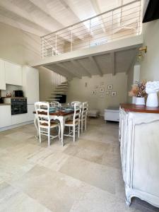 a kitchen and dining room with a table and chairs at Domus Lavinia ''Levante'' - Anzio in Anzio