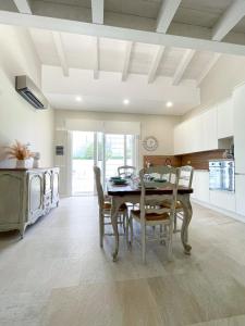 a kitchen and dining room with a table and chairs at Domus Lavinia ''Levante'' - Anzio in Anzio