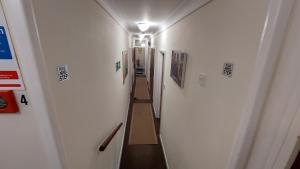 a hallway with a long corridor with a light on it at Tennyson Lodge in Mablethorpe