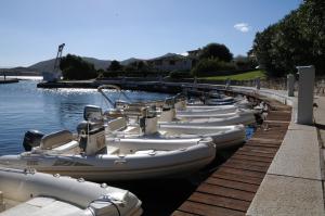 a row of boats are lined up in the water at Hotel Palumbalza Porto Rotondo in Porto Rotondo