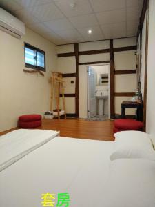 a bedroom with a bed and a bathroom at Chentien Changkuang Homestay in Changbin