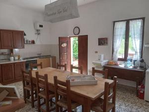 a kitchen with a wooden table and chairs in a room at Casa Biron in Molino SantʼAnna