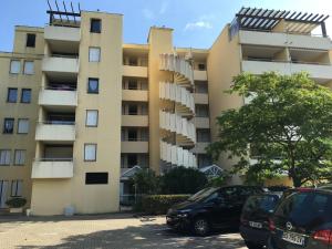 un condominio con auto parcheggiate davanti di Arcachon studio cabine avec accès direct à la plage ad Arcachon