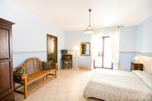 a bedroom with a bed and a desk in it at B&B Iris in Laterza
