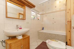ein Badezimmer mit Waschbecken, Toilette und Badewanne in der Unterkunft Ferienwohnungen Becker "Sonne & Meer" und "Strandliebe" in Kühlungsborn + 36 Fotos