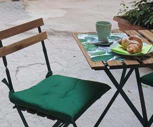 a table with a plate of bread and a cup of coffee at One Love Ortigia in Syracuse
