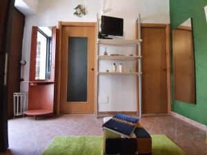 a living room with a door and a tv at One Love Ortigia in Syracuse