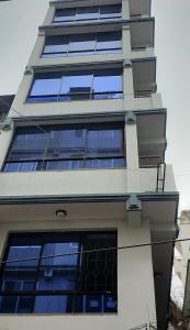 a tall building with windows on the side of it at Hotel Pristine in Kathmandu