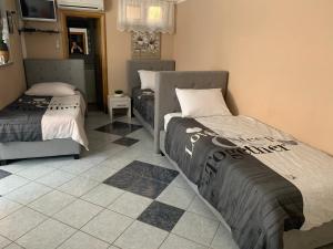 a bedroom with two beds and a tiled floor at Apartments Albatross in Novalja +47 photos