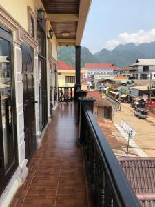a balcony of a building with a view of a town at Soutjai Guesthouse & Restaurant in Vang Vieng