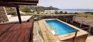 a swimming pool on a deck with a view of the ocean at Dammuso Surya Oleandro in Pantelleria