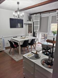 a kitchen and living room with a table and chairs at Apartament Woda Morska in Ustka