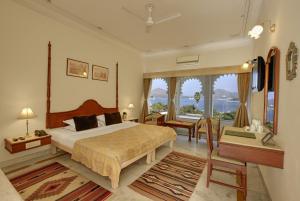 a bedroom with a bed and a room with a view at Rampratap Palace by Fateh Collection in Udaipur +51 photos