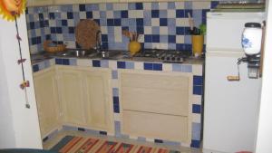 a kitchen with a sink and a refrigerator at Holiday Home La Quiete in Alghero +15 photos