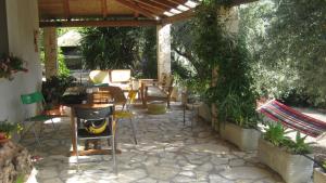 a patio with a table and chairs and a grill at Holiday Home La Quiete in Alghero