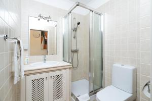 a bathroom with a shower and a toilet and a sink at Ria Olhao in Olhão +50 photos