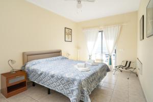 a bedroom with a bed and a chair at Ria Olhao in Olhão