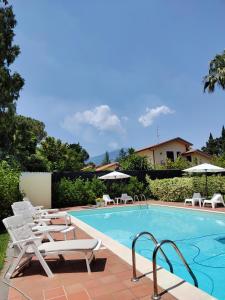 a swimming pool with chaise lounge chairs next to a swimming pool at Casa Vacanza Villa Romano in Nicolosi