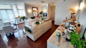 a store with a counter with plants on it at Hotel & Wellness Fra I Pini in Lignano Sabbiadoro