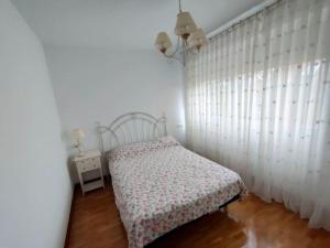 a small bedroom with a bed and a window at Casa amplia y luminosa cerca de Pamplona - Izarren Etxea in Orcoyen