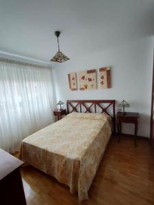 a bedroom with a bed and two side tables at Casa amplia y luminosa cerca de Pamplona - Izarren Etxea in Orcoyen
