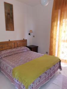 Кровать или кровати в номере Appartamento per vacanza