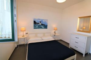 a small bedroom with a bed and a window at Villa di Marinella in Ascea