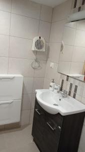 a bathroom with a sink and a mirror at VillaTzer - Traditional house with fireplace and garden in Tzermiádon +27 photos