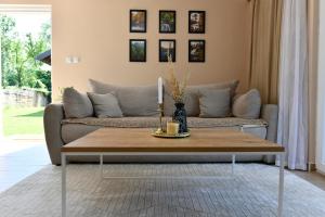a living room with a couch and a coffee table at Apartments Green Linden in Rakovica