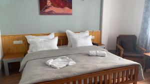 a bedroom with a bed with two towels on it at Mellow Fellow Hostel in Gangtok