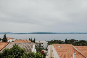 a view of the water and roofs of buildings at Apartments Borik Crikvenica in Crikvenica